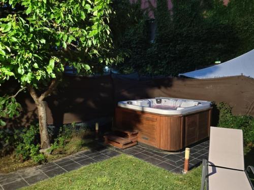 a hot tub sitting in a yard next to a tree at Marel Valladolid in Aldeamayor de San Martín