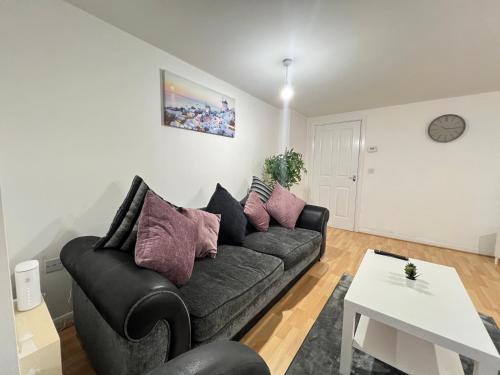 a living room with a couch and a table at High End Luxury 2 Bed Apartment Birmingham in Birmingham