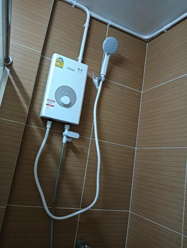 a bathroom with a microphone on a wall at Ben House Hatyai in Hat Yai