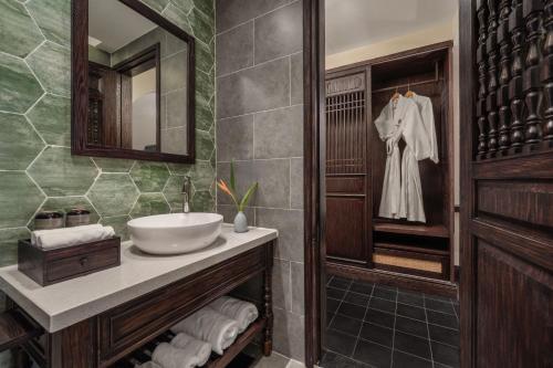 a bathroom with a sink and a mirror at The Signature Hoi An in Hoi An
