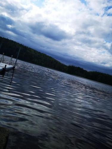 a boat sitting on a body of water at Sjö-Stuga 6 B in Landvetter