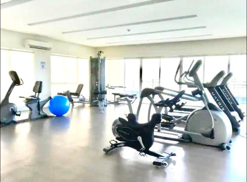 a gym with several exercise bikes in a room at DM Condo Unit Rental in Dumaguete
