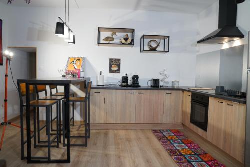 une cuisine avec une table et un comptoir dans l'établissement la roseraie, à Saint-Loup-Lamairé