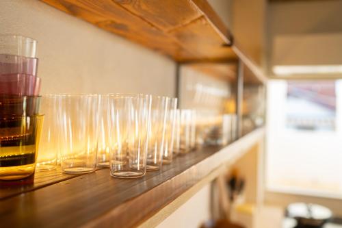 a row of wine glasses sitting on a counter at Room Tateyama in Hōjō
