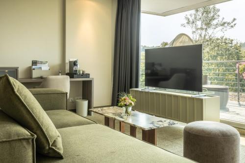 a living room with a large tv and a couch at Das Vesper in Sprockhövel