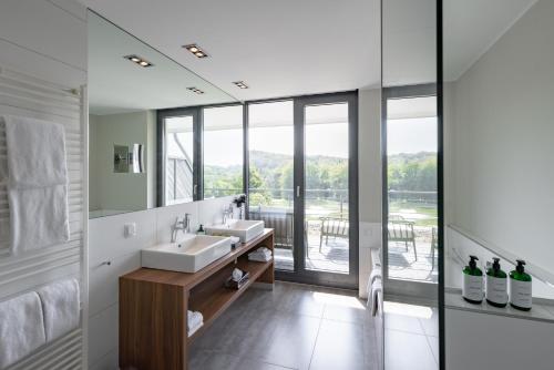 a bathroom with two sinks and a large window at Das Vesper in Sprockhövel