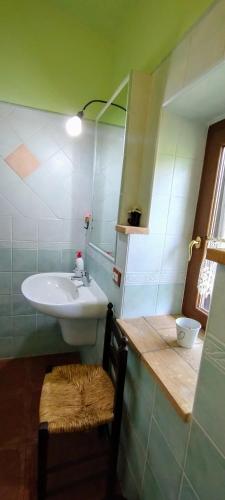 a small bathroom with a sink and a mirror at la maison in Todi