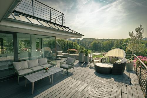a patio with a couch and chairs on a deck at Das Vesper in Sprockhövel