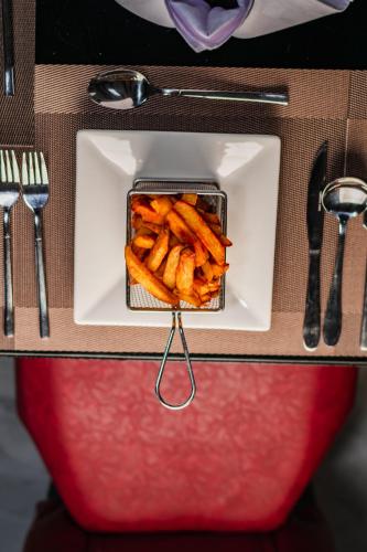 a container of fries on a plate on a table at Avian Court Hotel in Naivasha