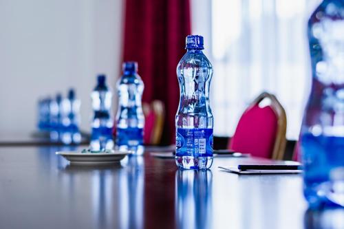 a bottle of water sitting on top of a table at Avian Court Hotel in Naivasha