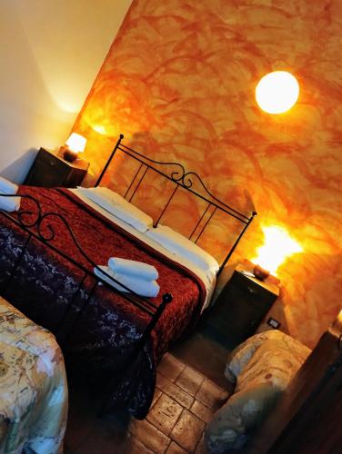 a bedroom with a bed with a painting on the wall at la maison in Todi
