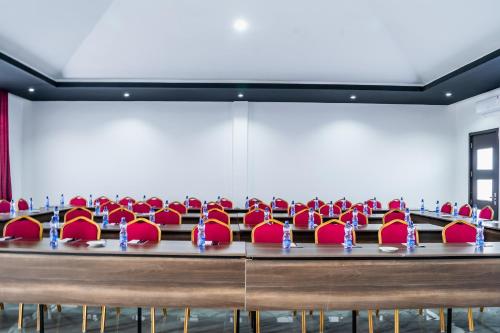 a row of red chairs in a conference room at Avian Court Hotel in Naivasha