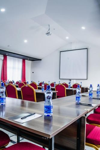 a conference room with tables and chairs with water bottles at Avian Court Hotel in Naivasha