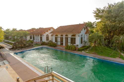 a house with a swimming pool in front of a house at Hoa Lu Garden Resort in Ninh Binh