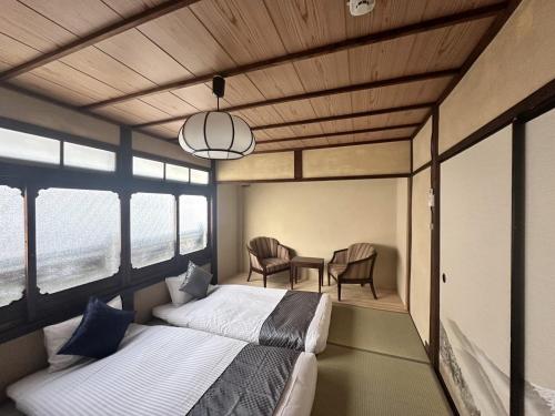 Ένα ή περισσότερα κρεβάτια σε δωμάτιο στο Tsumugu