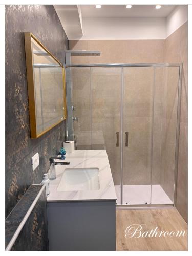 a bathroom with a sink and a shower at Tropical Inn Airport in Reggio Calabria
