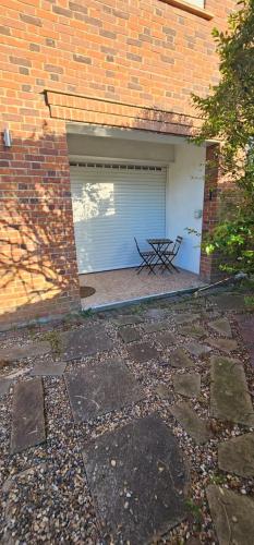 a garage with a garage door with a bench in it at Cyrus House in Dartford