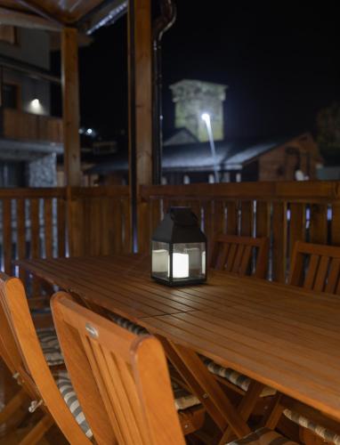 a lantern sitting on top of a wooden table at La Maison Mestia in Mestia