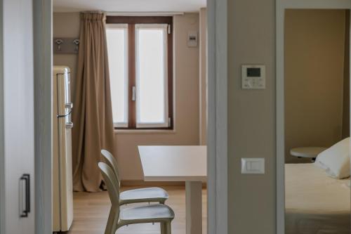 a room with a table and a chair and a bed at Residence San Michele in Costermano sul Garda