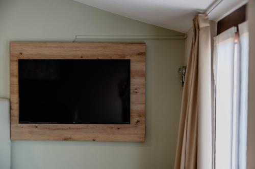 a flat screen tv on a wall in a room at Residence San Michele in Costermano sul Garda
