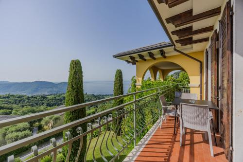 a balcony with chairs and a view of the countryside at Residence San Michele in Costermano sul Garda