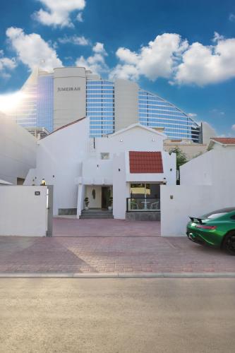 a green car parked in front of a building at Beautiful private villa with pool in Dubai