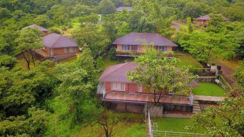 an aerial view of a house in a forest at Bougain Villa Resort Park By Dream Villas in Pune