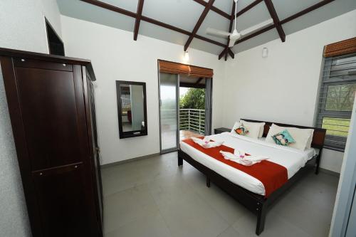 a bedroom with a bed with two pink flamingos on it at Bougain Villa Resort Park By Dream Villas in Pune