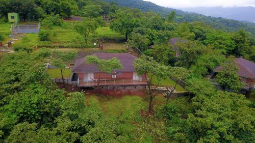 an overhead view of a house in the trees at Bougain Villa Resort Park By Dream Villas in Pune