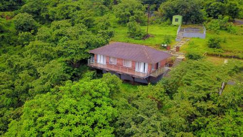 an aerial view of a house in the middle of a forest at Bougain Villa Resort Park By Dream Villas in Pune