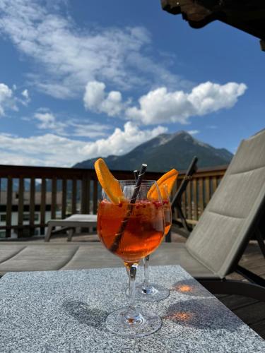 a drink sitting on a table on a patio at Sonnenburg Hotel in Ehrwald