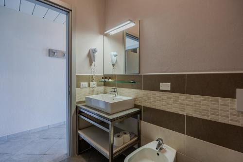 a bathroom with a sink and a toilet and a mirror at Residence San Michele in Costermano sul Garda