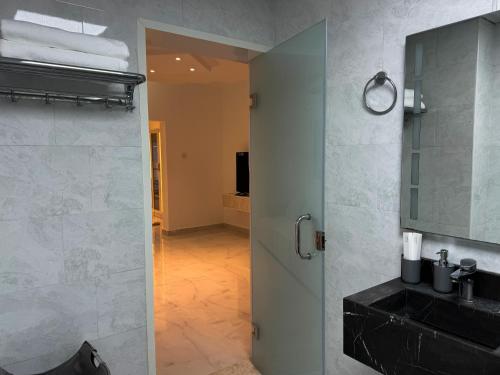a bathroom with a shower with a sink and a mirror at Beautiful private villa with pool in Dubai