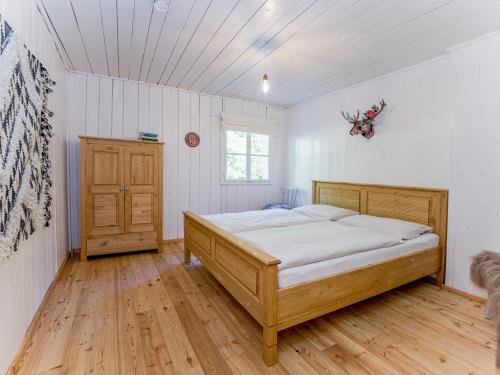 a bedroom with a bed and a wooden floor at Talsenalm Wald Habitat in Waidring