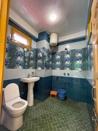 a bathroom with a toilet and a sink at Trippy Homestay in Kasol