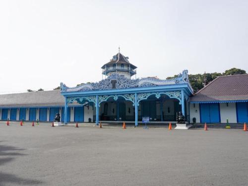 a blue building with a tower on top of it at Larisae Setia Kawan Hotel in Solo