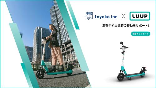 a woman riding an electric scooter on a street at Toyoko Inn Shin-osaka Higashi-mikuni Ekimae in Osaka