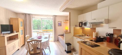 une cuisine avec une table et une salle à manger dans l'établissement MONTANA 1 - G4 - Studio 4 pers, à Les Deux Alpes