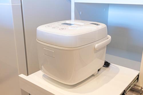a white toilet sitting on top of a counter at 海の見える高層階グループファミリー歓迎コストコ近くThe琉球タワー9A in Yonabaru