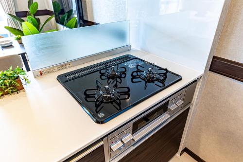a tablet on top of a kitchen counter at 海の見える高層階グループファミリー歓迎コストコ近くThe琉球タワー9A in Yonabaru
