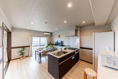 a kitchen with a sink and a counter top at 海の見える高層階グループファミリー歓迎コストコ近くThe琉球タワー9A in Yonabaru
