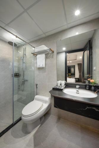 a bathroom with a toilet and a sink and a shower at SQ Hang Gai Hotel & Spa in Hanoi