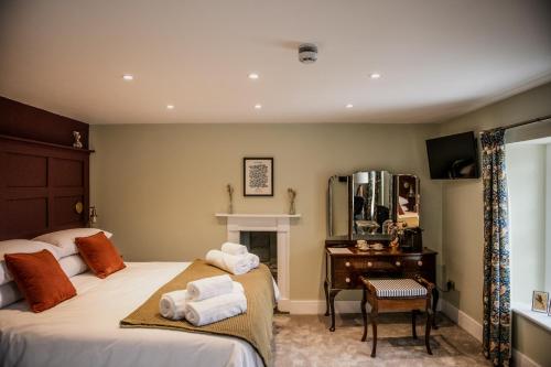 a bedroom with two beds and a desk and a mirror at The Heathcock Boutique Hotel - Room 2 in Cardiff