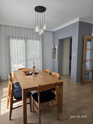 a dining room with a wooden table and chairs at Villa Kyrenia in Lapithos