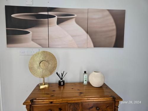 a lamp on top of a wooden table with vases at Villa Kyrenia in Lapithos