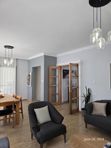 a living room with two couches and a table at Villa Kyrenia in Lapithos