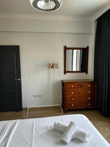 a bedroom with a bed and a dresser and a mirror at Villa Kyrenia in Lapithos