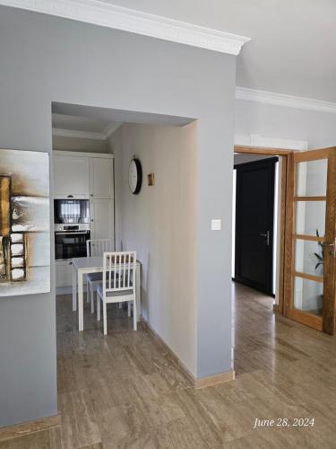 a living room with a table and a kitchen at Villa Kyrenia in Lapithos