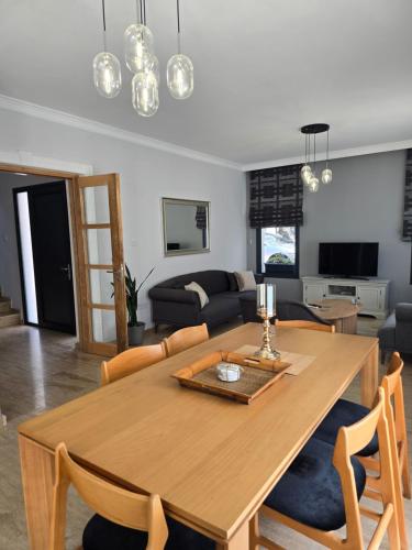 a living room with a wooden table and a couch at Villa Kyrenia in Lapithos