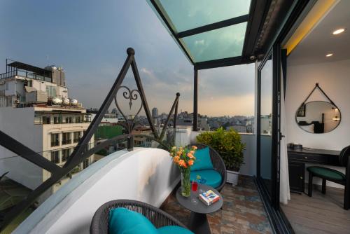 a balcony with a view of a city at SQ Hang Gai Hotel & Spa in Hanoi